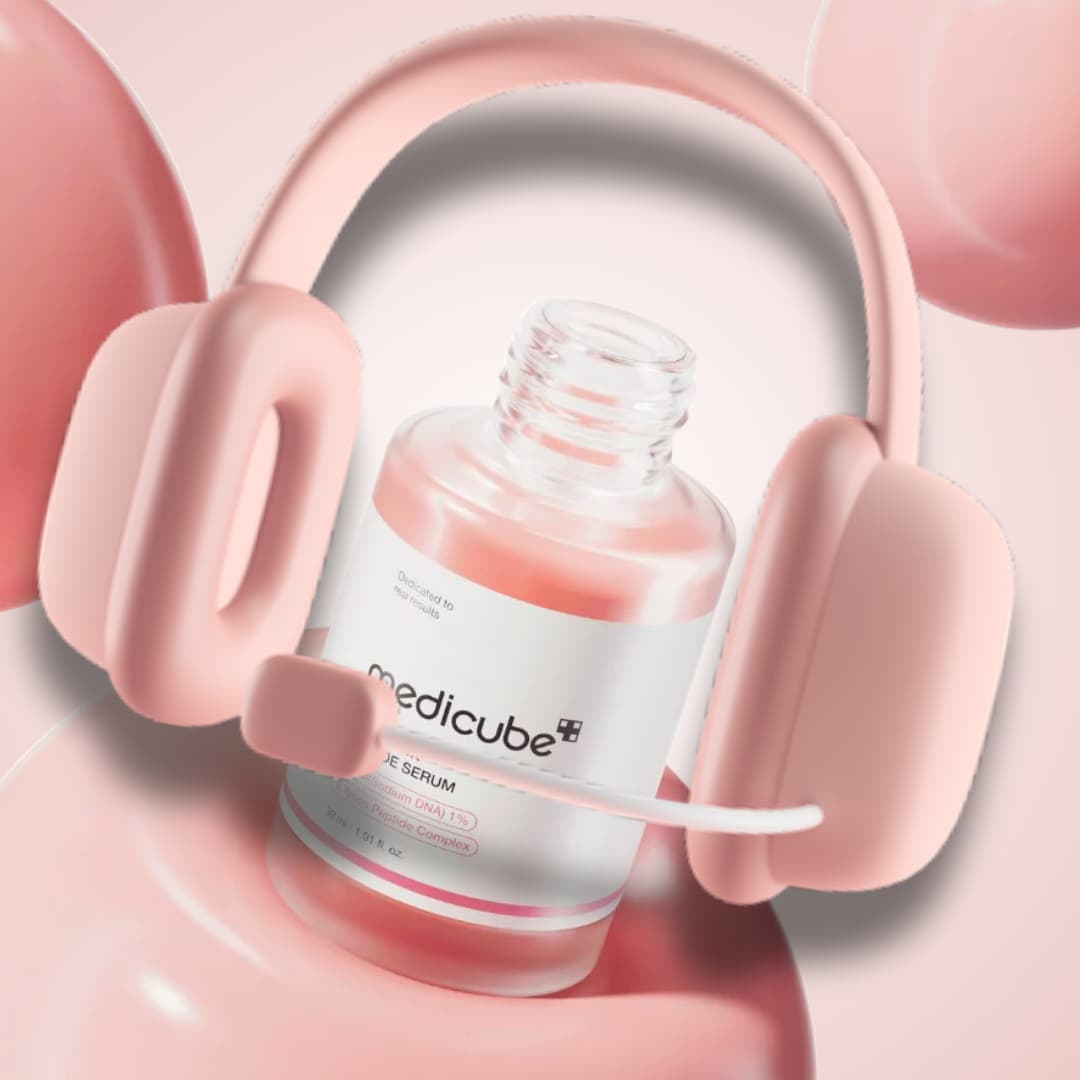 Medicube serum bottle wearing pink headphones with pink background