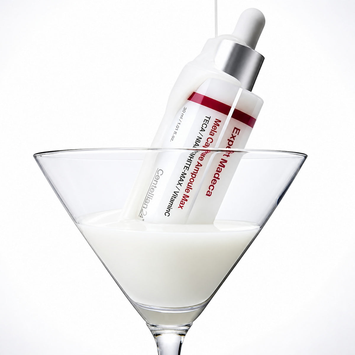 CENTELLIAN24 Expert Madeca Mela Capture Ampoule Max 30ml in a white dropper bottle, partially submerged in a glass of milky liquid against a clean white background.
