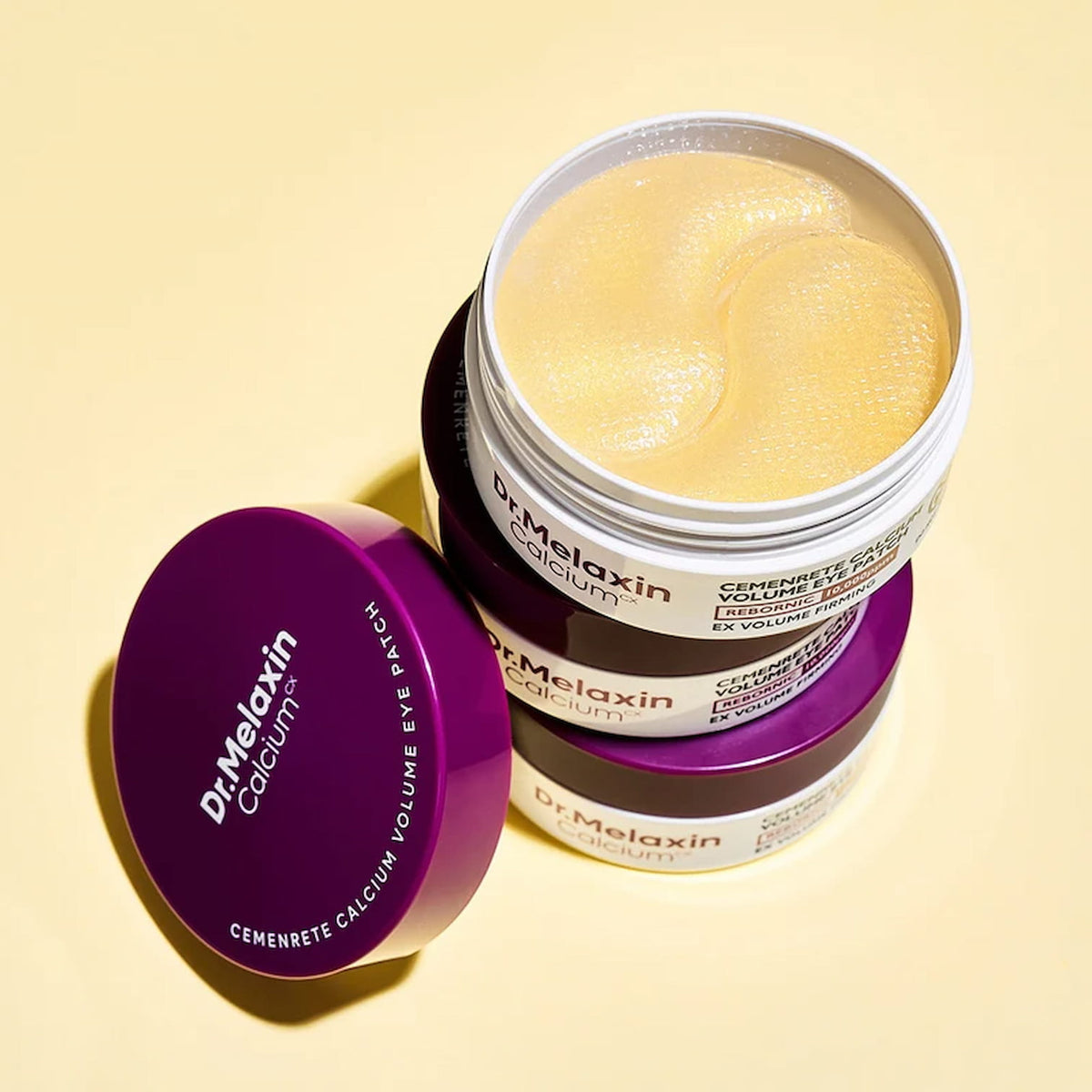 Dr. Melaxin Cemenrete Calcium Calcium Volume Eye Patch jar with purple lid on a yellow background