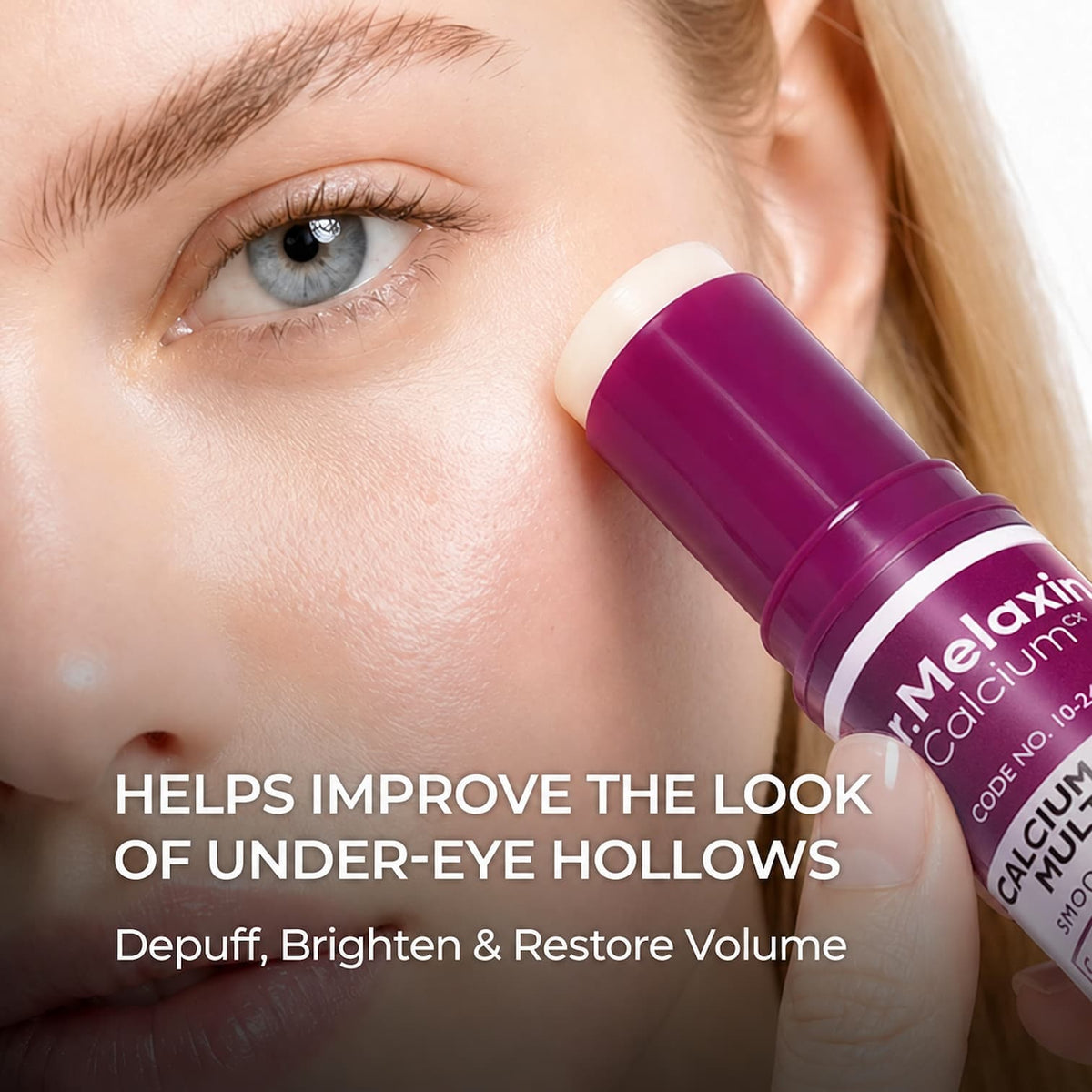 Close-up of a woman's eye area using an under-eye cream stick. The product is a purple and white tube labeled Dr.Melaxin Calcium