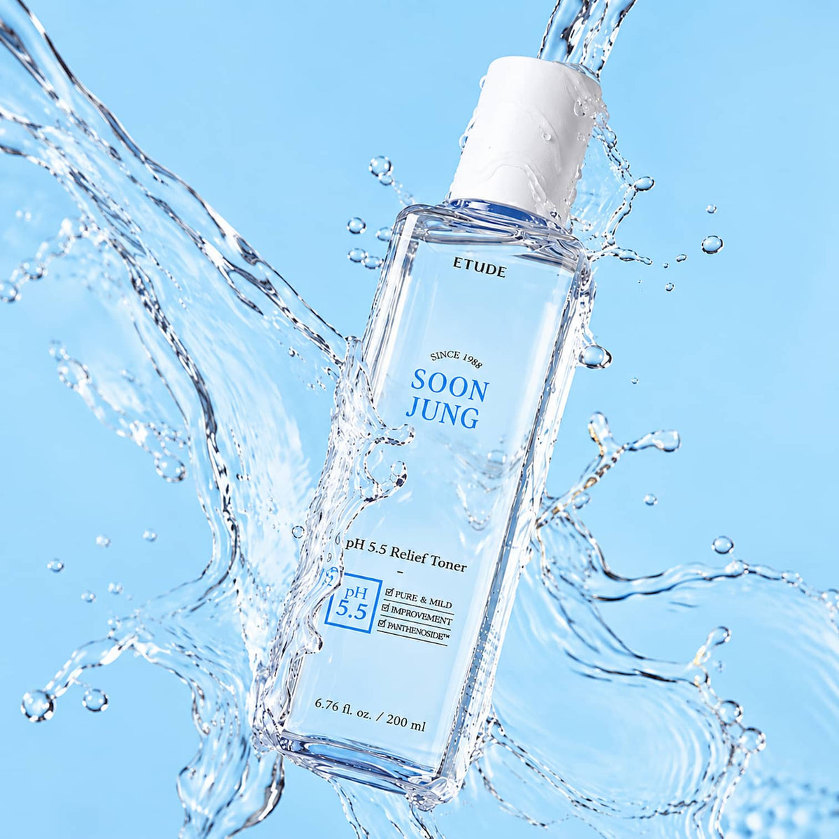 A clear bottle of ETUDE Soon Jung pH 5.5 Relief Toner floating in a dynamic splash of water against a bright blue background.