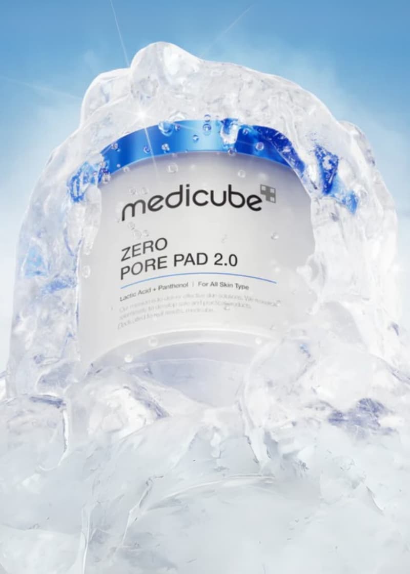 Medicube Zero Pore Pad product with water droplets on light blue background background